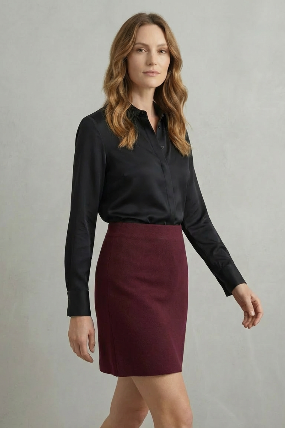 Women's V-neck long sleeve knit mini skirt set featuring a black satin shirt and a maroon knit mini skirt, front view.