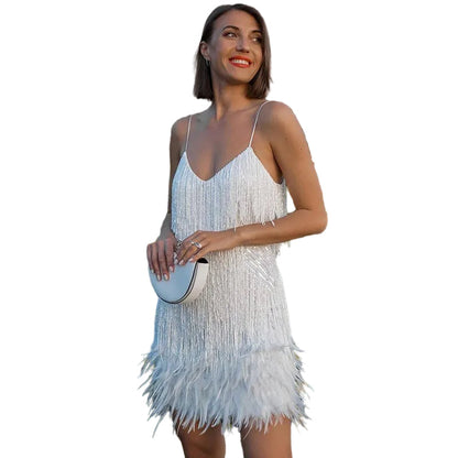 White V-neck sequin feather mini dress with spaghetti straps, shown outdoors with a white clutch.