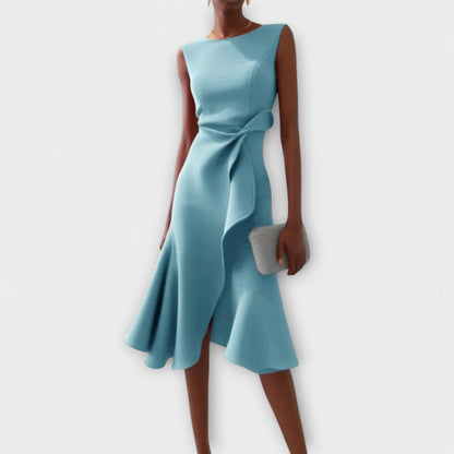 Light blue sleeveless midi dress showcasing an asymmetric ruffled skirt and a stylish tie-front detail, ideal for vacation dresses.