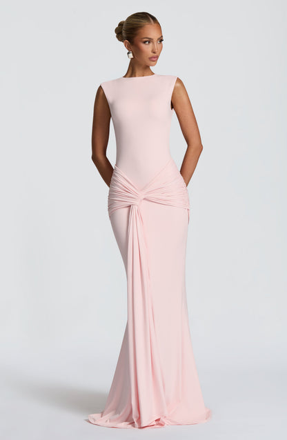 Blush pink sleeveless maxi dress, angled front view showing ruched hip detail and long drape