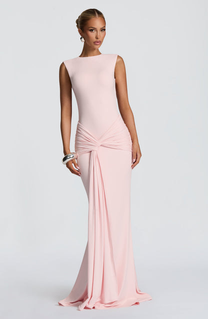 Front view blush pink maxi dress with smooth high neckline, ruched waist wrap, and draped panel