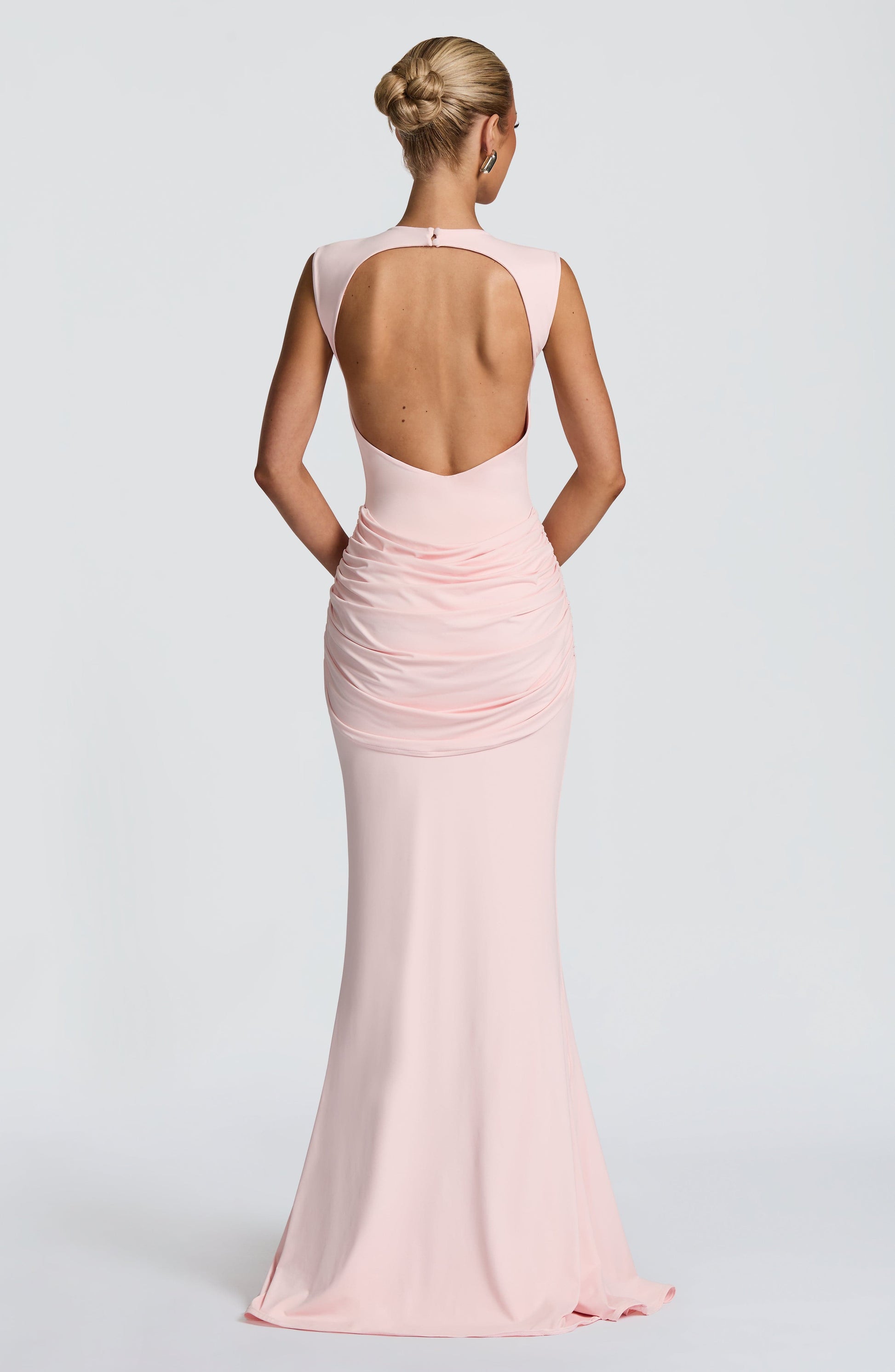 Back view blush pink backless maxi dress with large open cutout and ruched skirt detailing