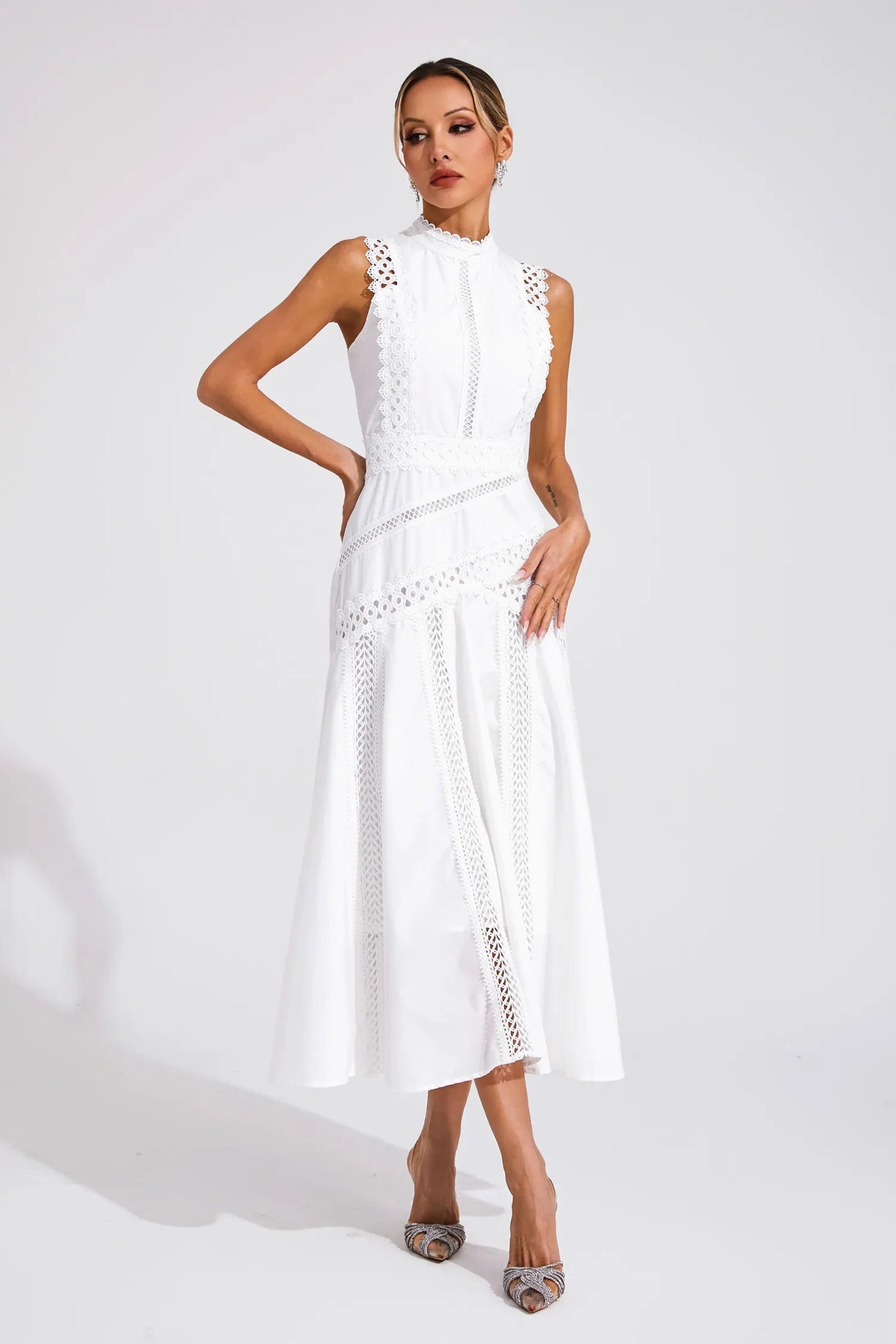 White sleeveless cutwork high neck midi dress for women, featuring a full A-line skirt and delicate lace trim.
