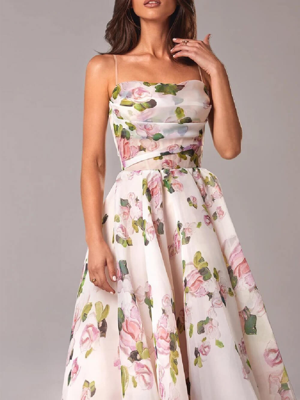Close-up of the women's floral cowl neck midi dress in white with pink and green floral pattern, highlighting the delicate fabric and bodice detail.