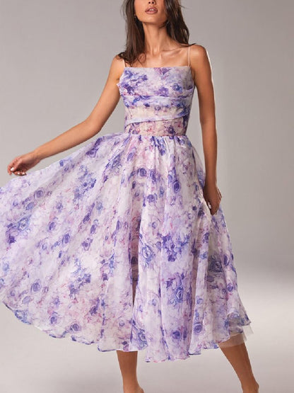 Women's floral cowl neck midi dress in a light purple and blue watercolor floral print, with a full, flowing skirt for a vacation outfit.