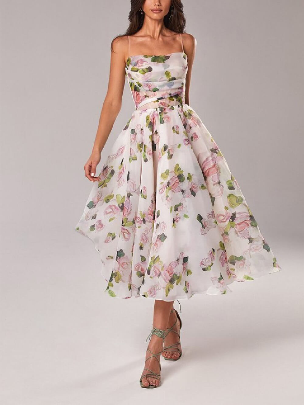 Women's floral cowl neck midi dress in white with pink and green floral print, spaghetti straps, and a flowing skirt, perfect for wedding guests.