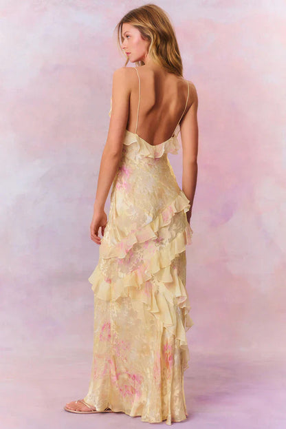 Back view pale yellow floral slip maxi dress with low back, thin straps, and diagonal ruffle detail
