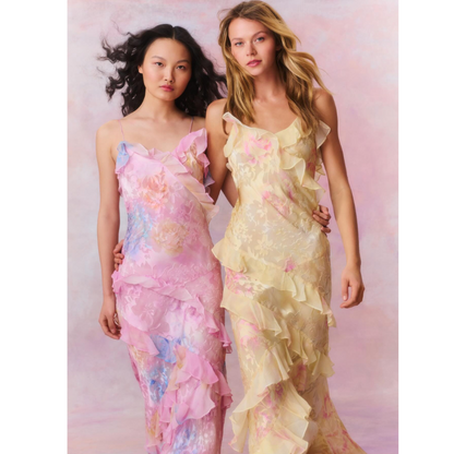 Two floral slip maxi dresses with ruffles shown together, one pink pastel and one pale yellow