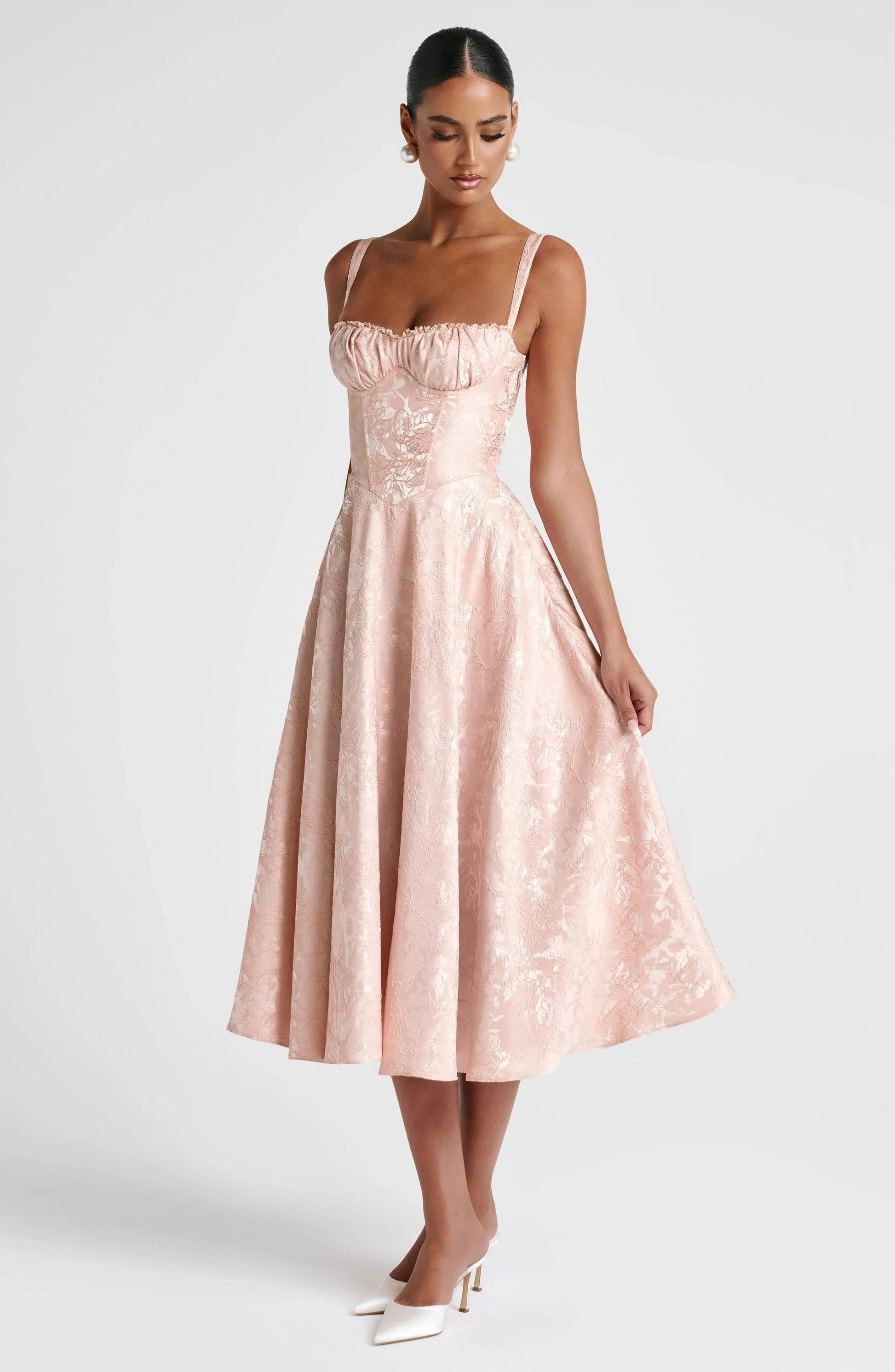 Blush floral square neck midi dress shown at three-quarter angle with structured bodice and flared skirt