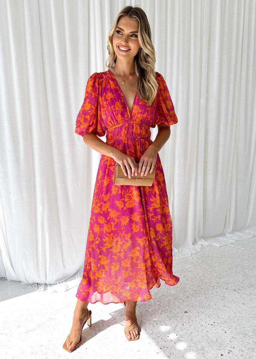 Flowy pink and orange floral maxi dress for women, featuring a V-neck, cinched waist, and short puff sleeves, ideal for wedding guest dresses.