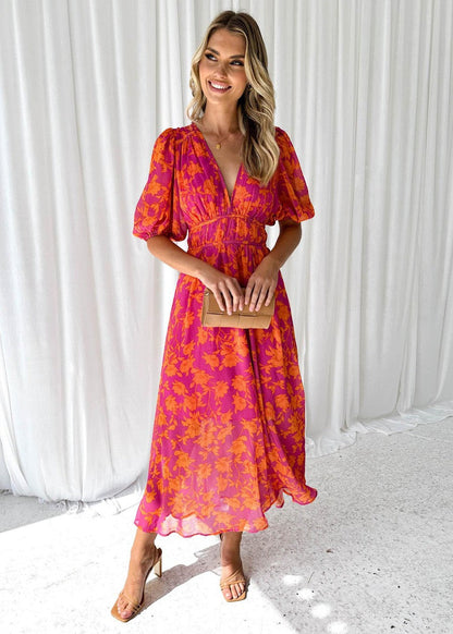 Flowy pink and orange floral maxi dress for women, featuring a V-neck, cinched waist, and short puff sleeves, ideal for wedding guest dresses.