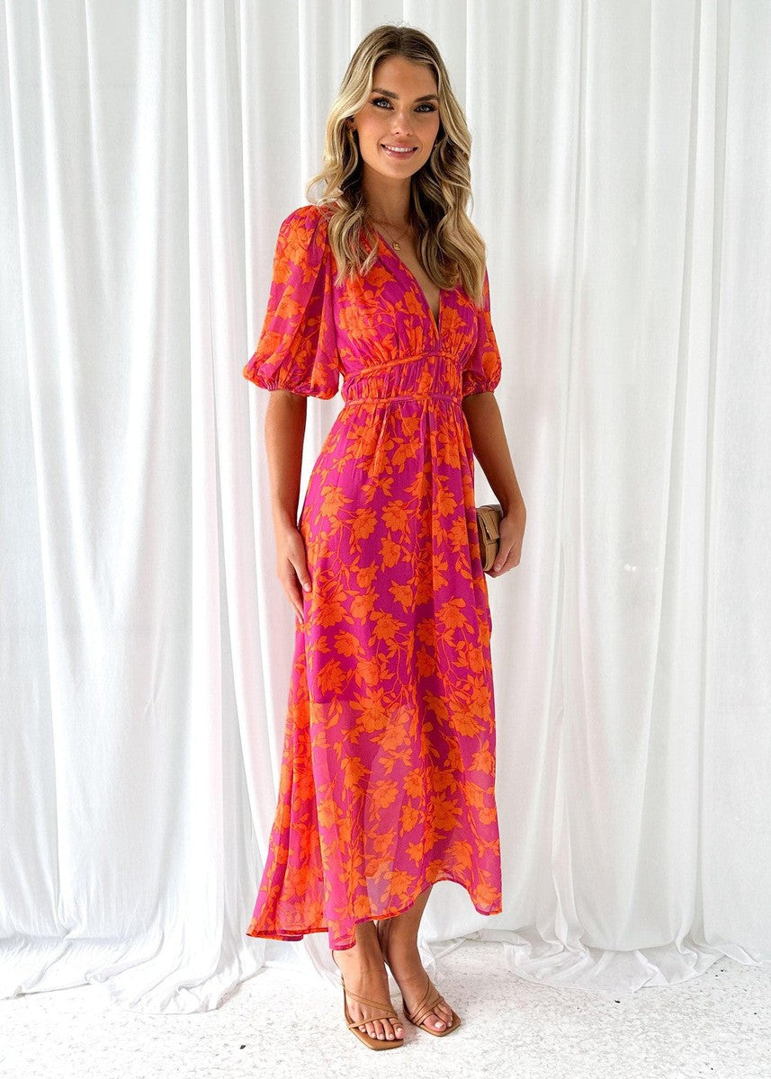 Side view of a stylish pink and orange floral maxi dress with a V-neck, short sleeves, and a flattering silhouette, suitable for elegant dresses for wedding guests.