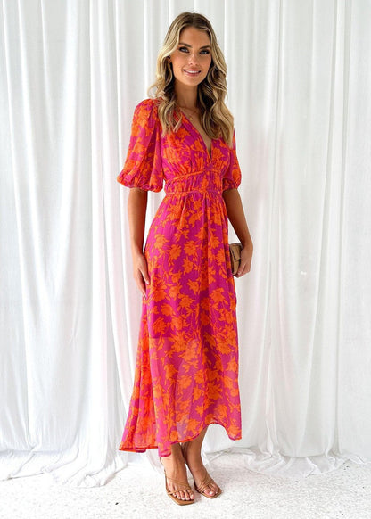 Side view of a stylish pink and orange floral maxi dress with a V-neck, short sleeves, and a flattering silhouette, suitable for elegant dresses for wedding guests.