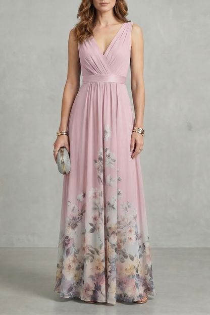 Soft pink floral V-neck maxi dress with a ruched bodice and flowing skirt, adorned with a subtle floral pattern, ideal for wedding guests.