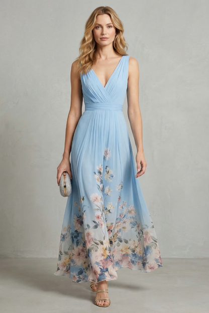 Front view of a women's light blue floral v-neck ombre maxi dress, featuring a flowing skirt with a botanical print.