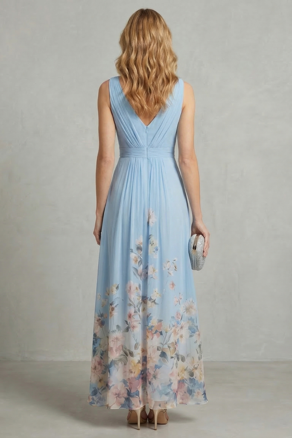 Back view of a women's light blue floral ombre maxi dress, highlighting the v-back design and flowing skirt.