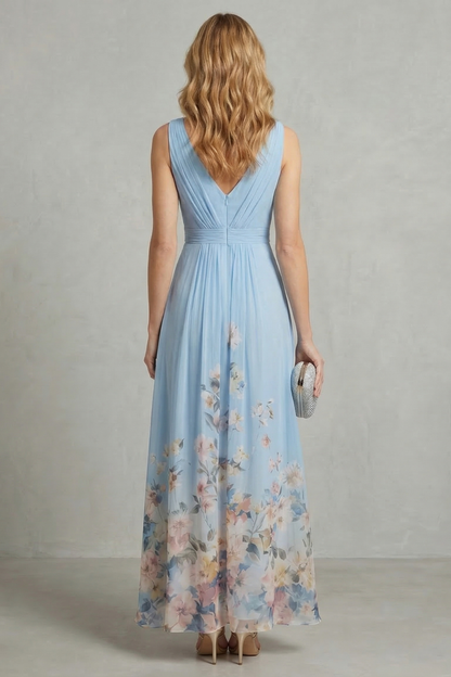 Back view of a women's light blue floral ombre maxi dress, highlighting the v-back design and flowing skirt.