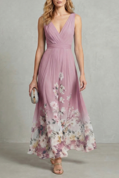 Full-length view of a dusty rose floral ombre maxi dress with a v-neck and pleated bodice, an elegant dress for wedding guests.