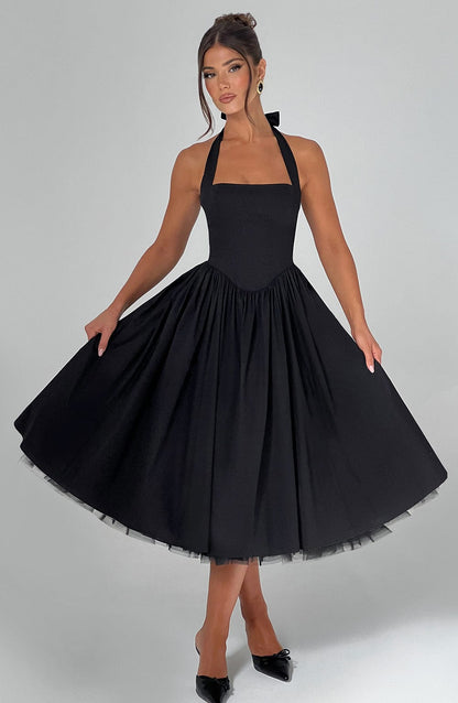 Black halter neck midi dress with a flattering square neckline and a full skirt, perfect as a sophisticated wedding guest dress.