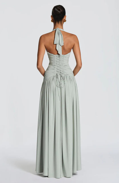 Back view sage green halter backless maxi dress with tie neck and lace-up corset back detail