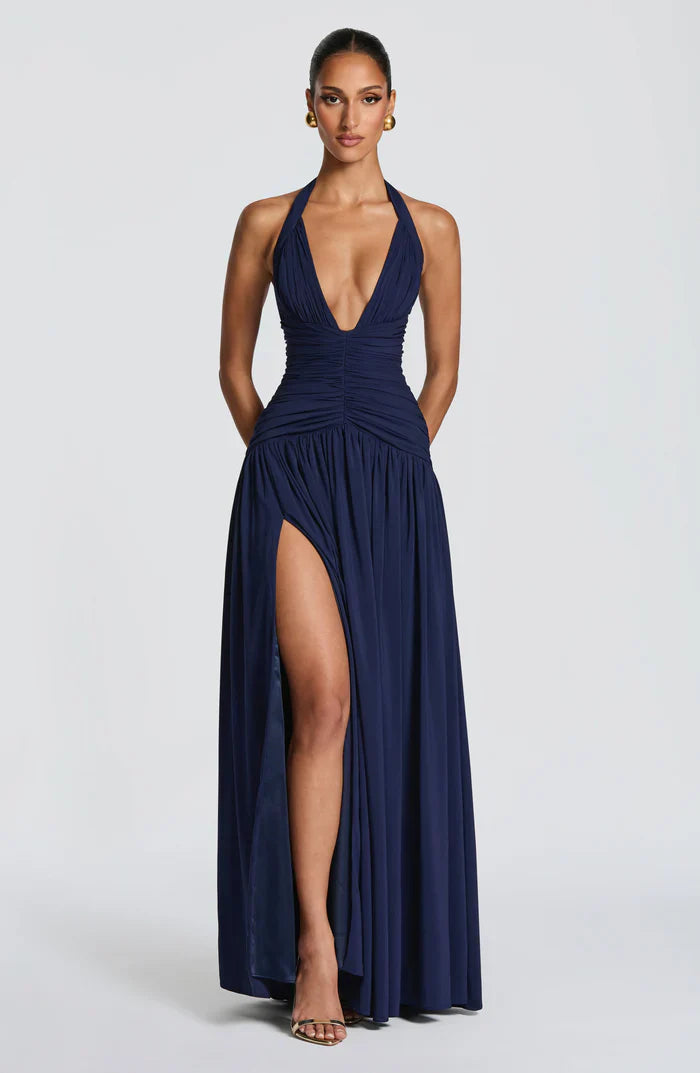 Navy V-neck halter maxi dress front view featuring ruched bodice and dramatic left leg slit