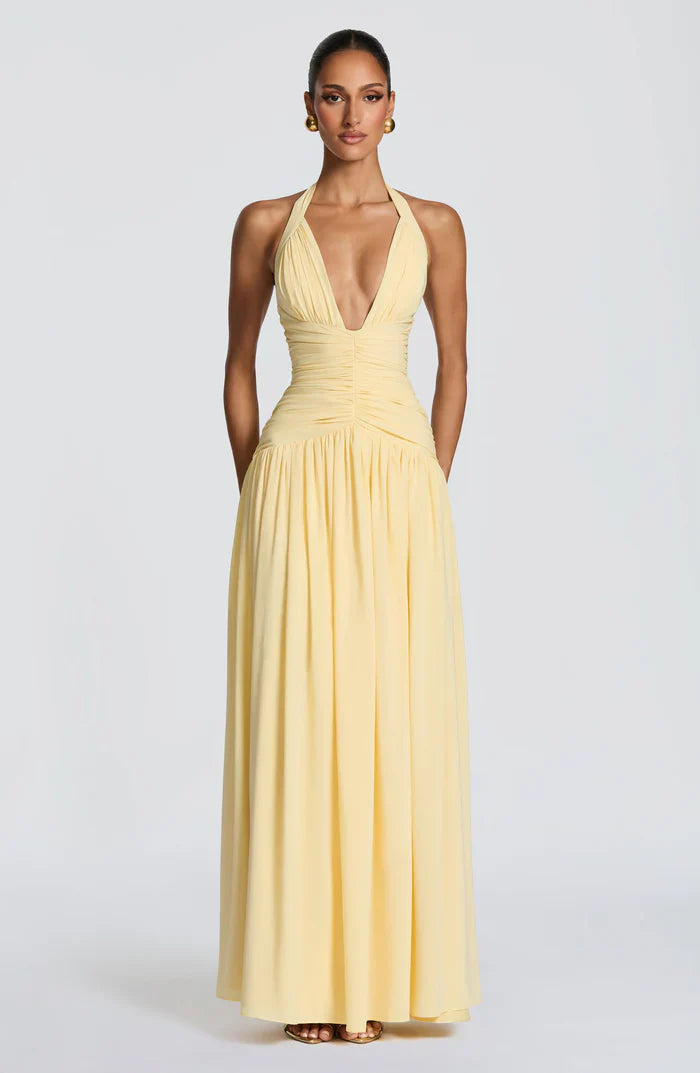 Pale yellow halter V-neck backless maxi dress with ruched waist and soft flowing full-length skirt
