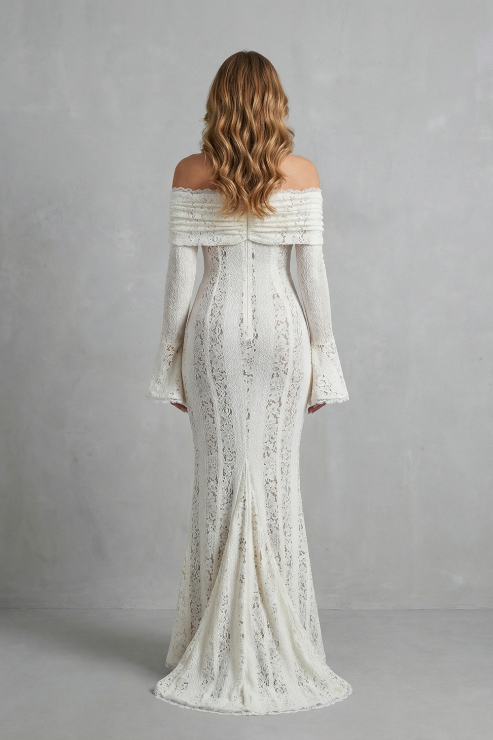 Back view of a white off-shoulder lace maxi dress, highlighting the floor-length skirt with a subtle train and the elegant silhouette.