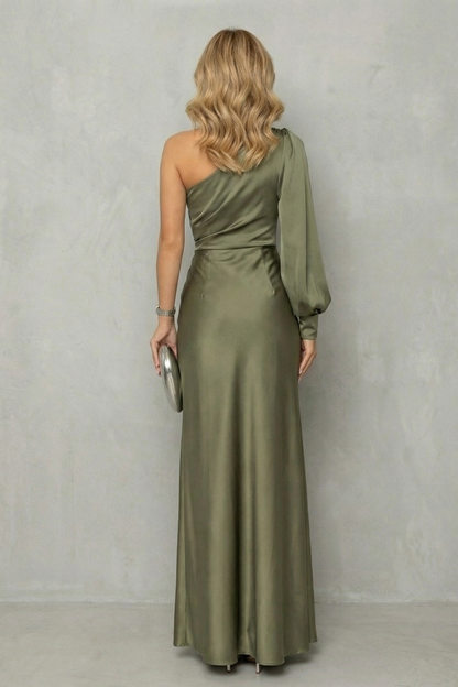 Back view of the olive green one-shoulder maxi dress, highlighting the flowing skirt and single long sleeve.