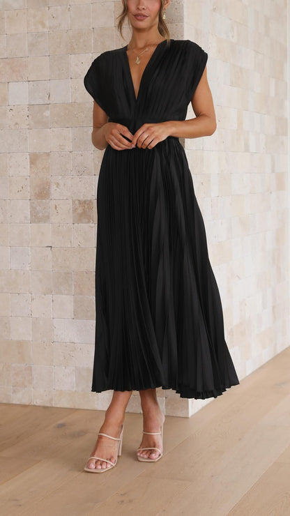 Front view of a black pleated v-neck midi dress, featuring cap sleeves and a flowing skirt, ideal for wedding guests.
