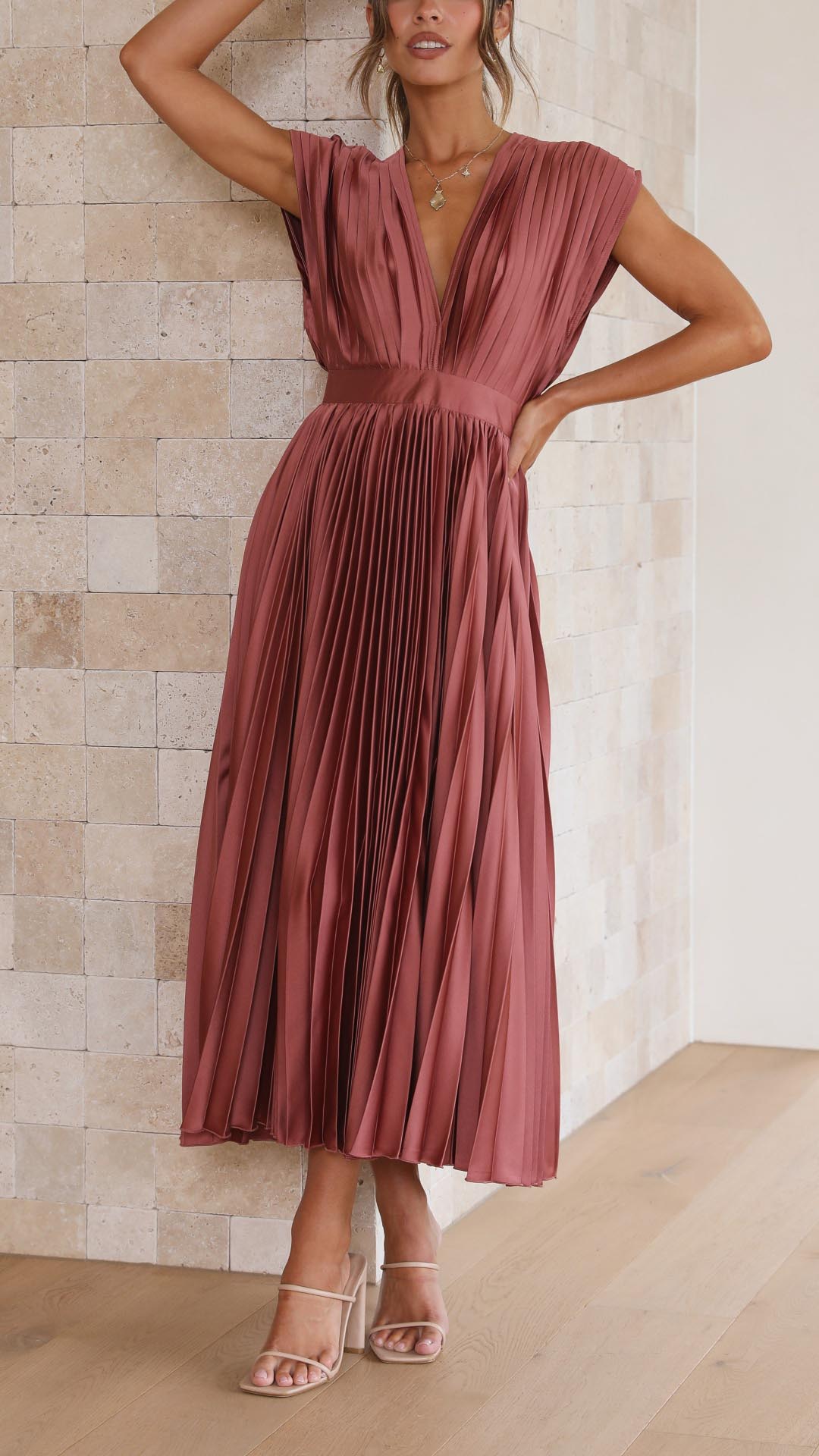 Rosewood women's pleated midi dress with a deep V-neck, showcasing the delicate pleats and a flattering silhouette ideal for vacation dresses.