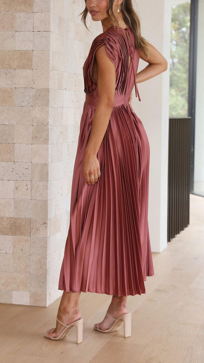 Side view of the rosewood pleated V-neck midi dress, revealing the intricate pleating details and a tie-back feature, an elegant dress for wedding guests.