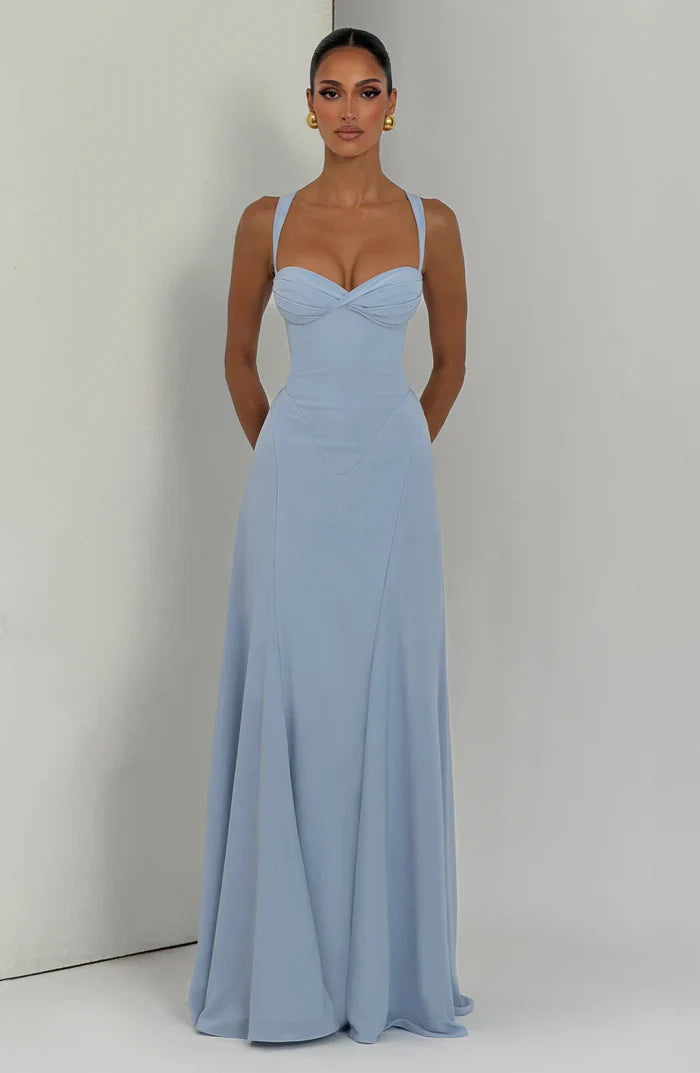 Light blue sweetheart ruched corset maxi dress styled full length with flowing hem, front view on wall set