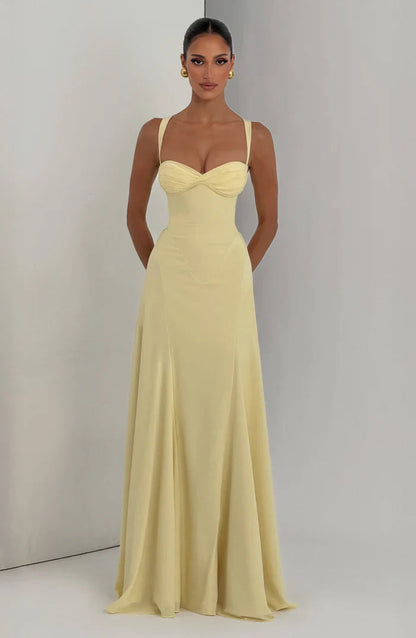 Pale yellow sweetheart corset maxi dress shown full length with soft drape and flared hem, front view