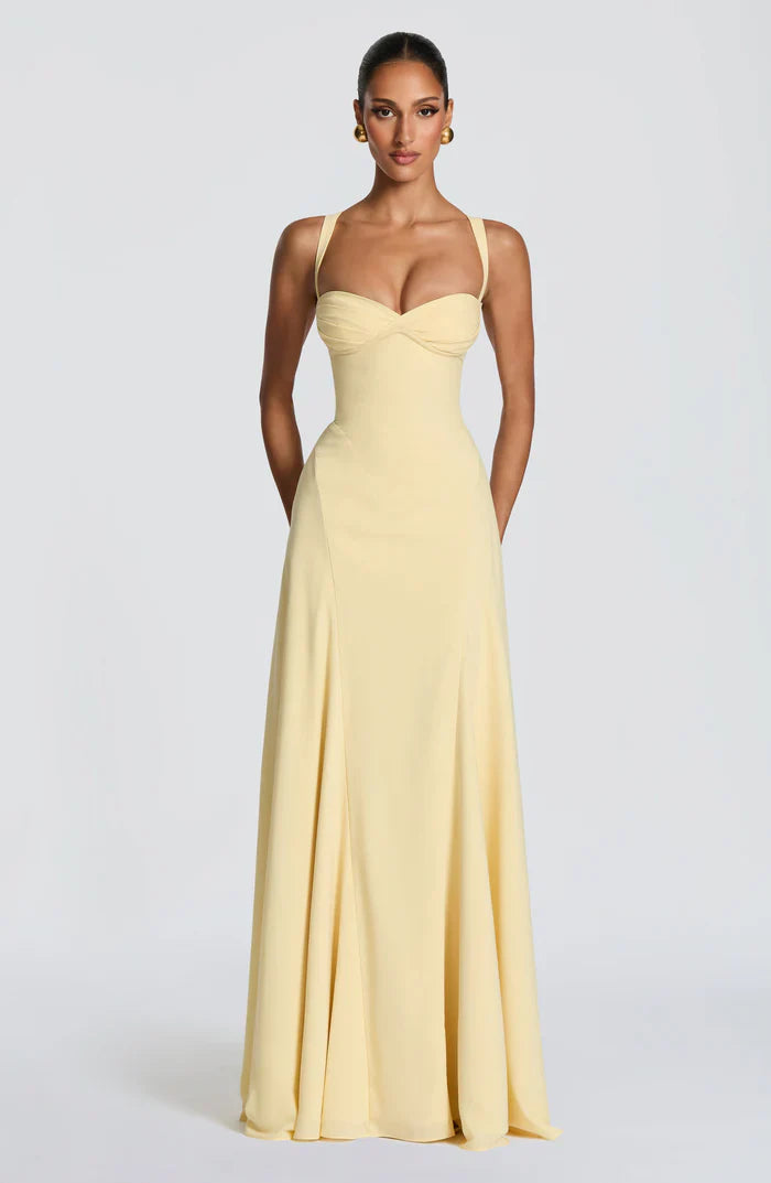 Pale yellow sweetheart ruched corset maxi dress with wide straps and flowing A-line skirt, front view