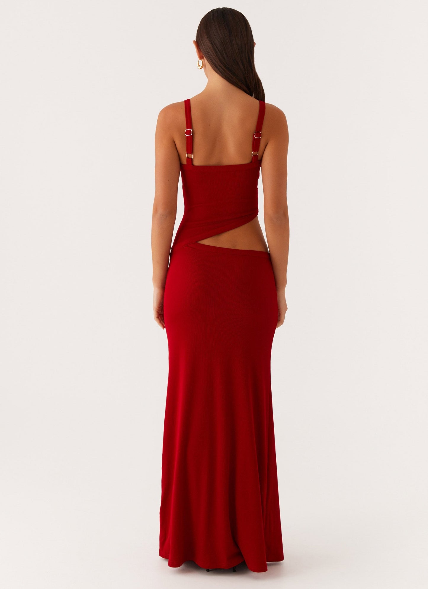 Back view of the deep red bodycon maxi dress, showing the open back and side cut-out details.
