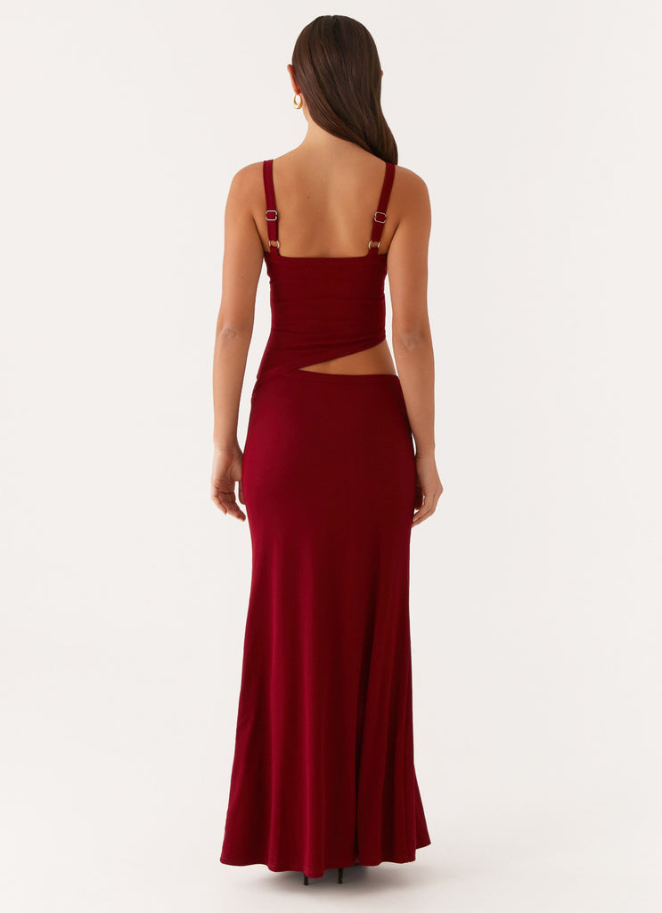 Back view of the deep red bodycon maxi dress, highlighting the adjustable straps and a side cut-out.
