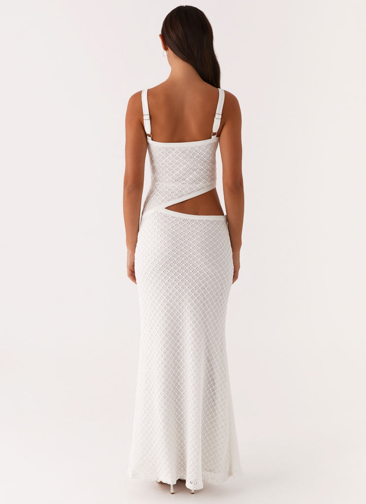 Back view of a white crochet cut out maxi dress, highlighting the side cut-out and adjustable straps.