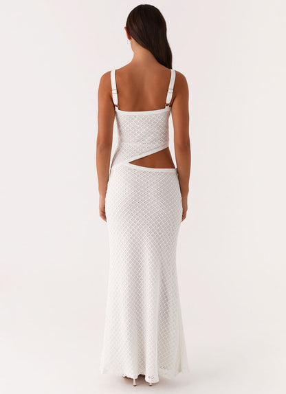 Back view of a white crochet cut out maxi dress, highlighting the side cut-out and adjustable straps.