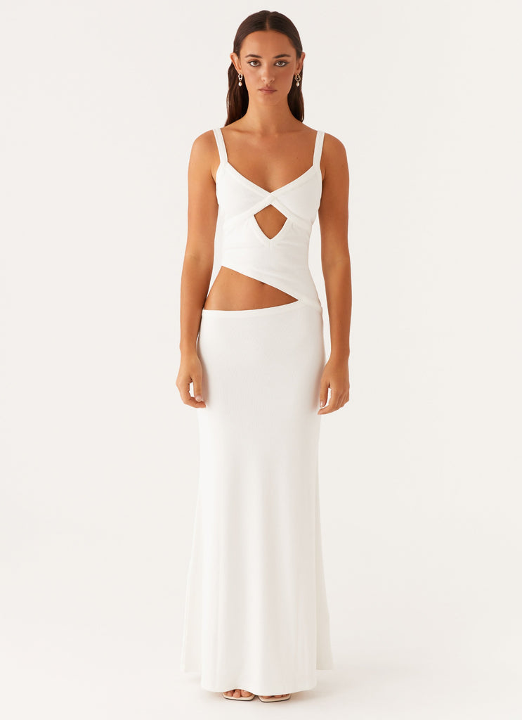 Front view of a white knit maxi dress with a criss-cross bodice and a single side cut-out.