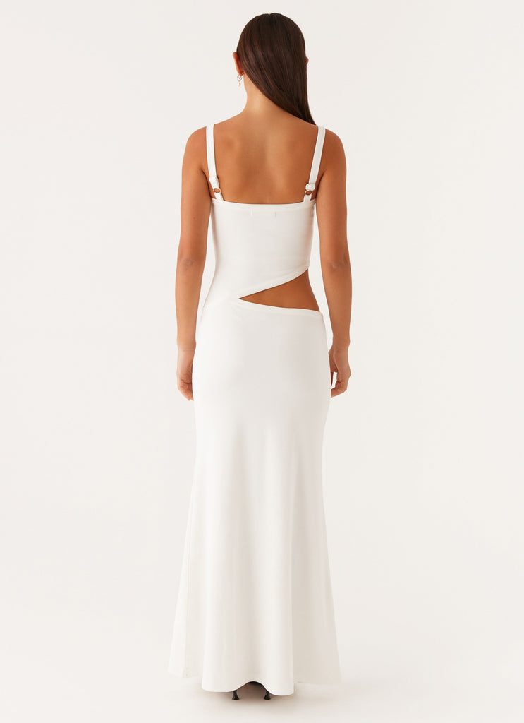 Back view of a white knit maxi dress, showing the elegant silhouette and side cut-out detail.