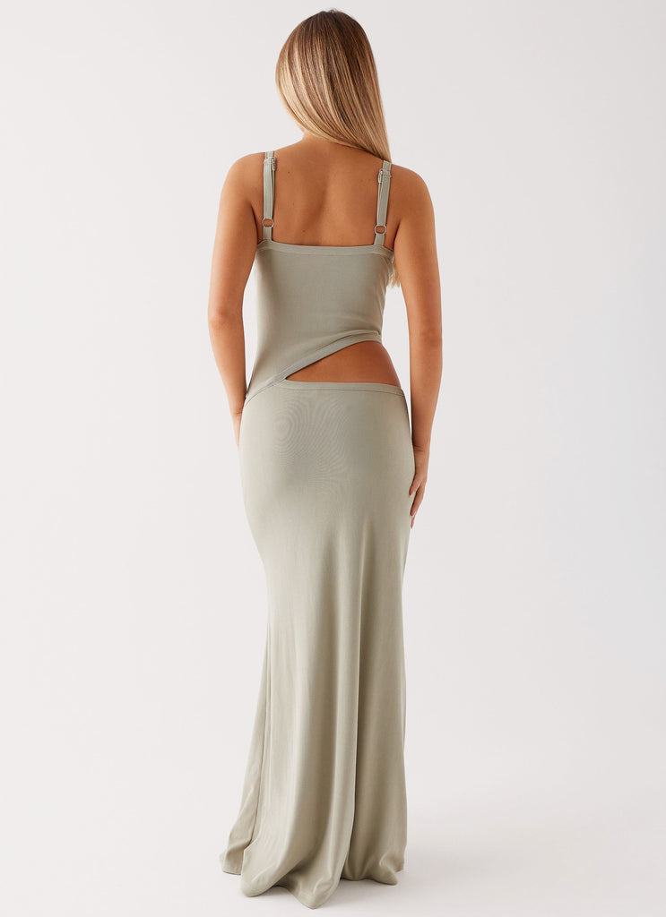 Back view of a sage green knit maxi dress, showcasing the cut-out detail and adjustable straps.