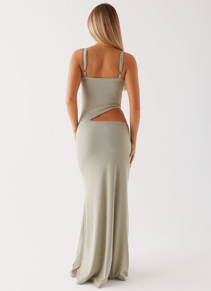 Back view of a sage green knit maxi dress, showcasing the cut-out detail and adjustable straps.