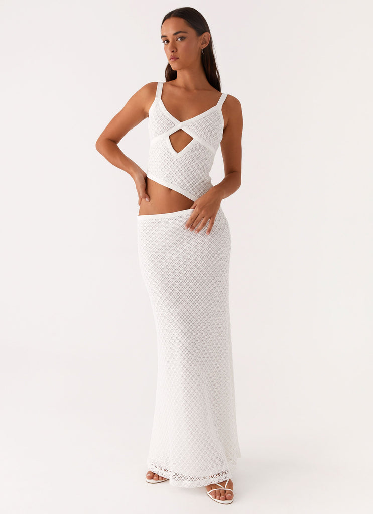 Front view of a white crochet cut out maxi dress with a criss-cross bodice and keyhole detail, perfect for vacation outfits.