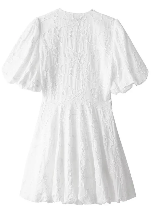 Back view flat lay of white floral puff sleeve mini dress with textured jacquard fabric and gathered waist