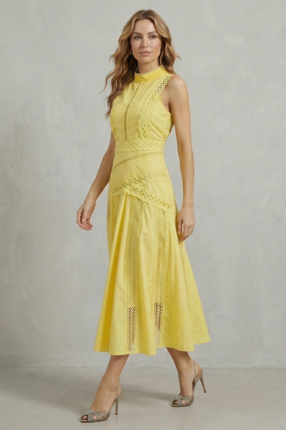 Side profile of a women's yellow lace panel midi dress, highlighting the A-line silhouette and textured lace trim.