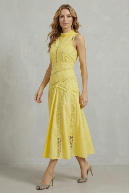 Side profile of a women's yellow lace panel midi dress, highlighting the A-line silhouette and textured lace trim.