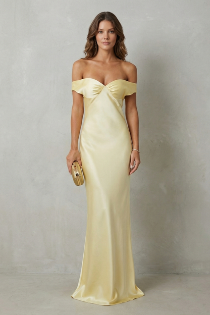 Full-length view of a yellow off-shoulder satin maxi dress, elegant for wedding guests or vacation outfits.